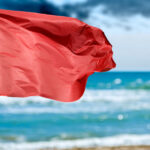 Olas Altas Beach stands under a red flag