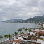 Puerto Vallarta stays warm and mostly cloudy today, with showers most likely in the afternoon and again later tonight. Watch the bay and hillsides.